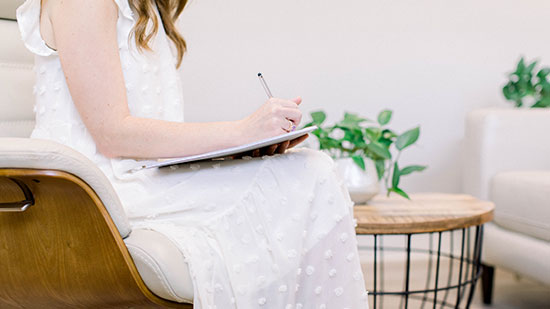 Melissa writing in a notebook