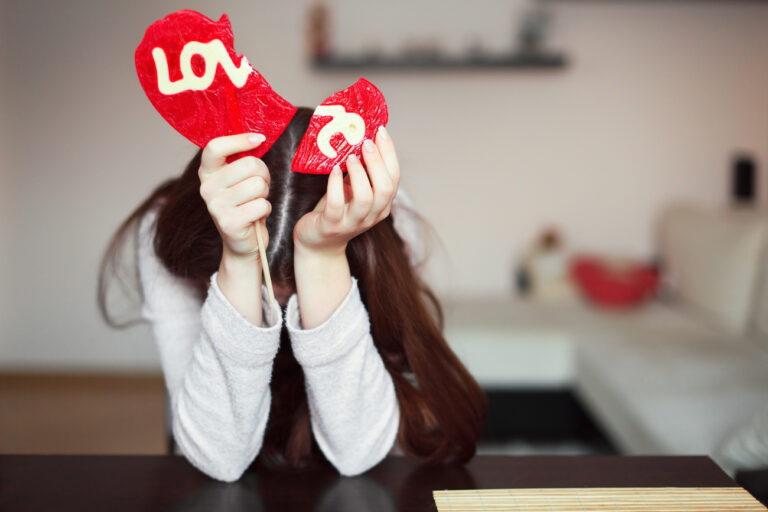 Woman holding broken heart