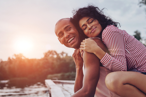 Happy Couple leaning on a balcony during sunset