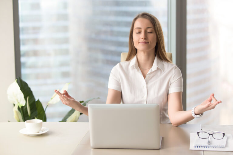 Woman Meditating at her Desk