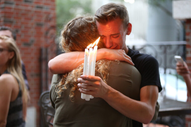 Two people hugging and crying together